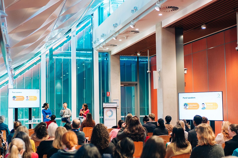 audience watching the stage where a panel discussion is taking place