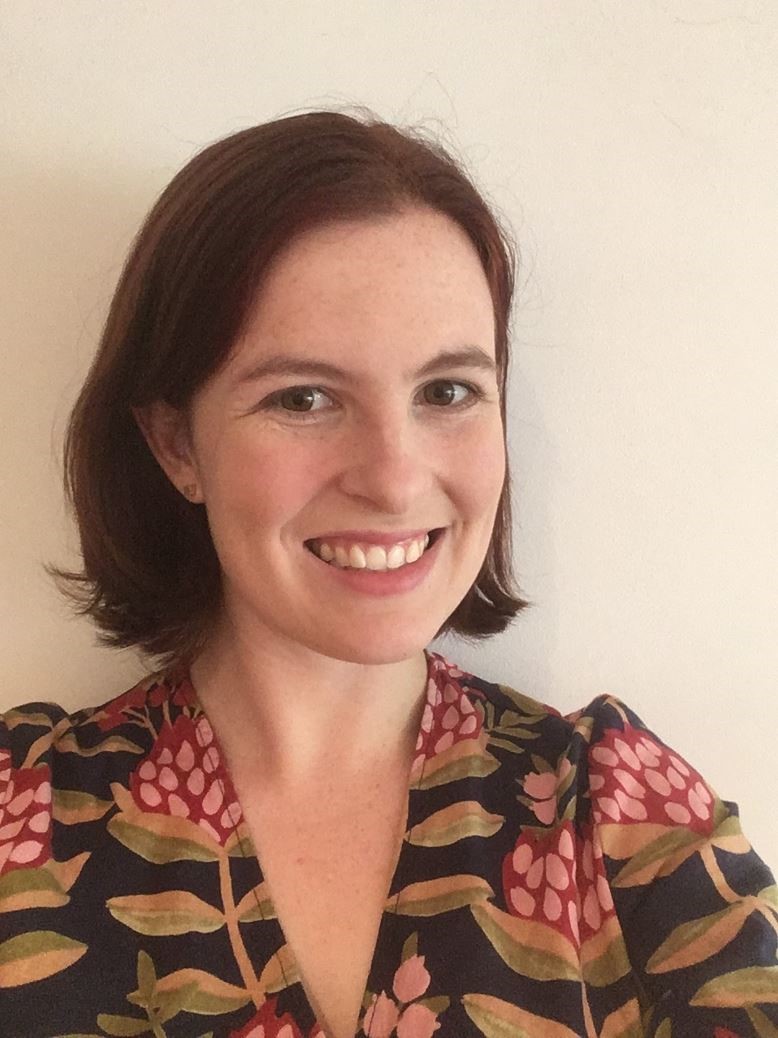 Woman with short hair smiling at the camera