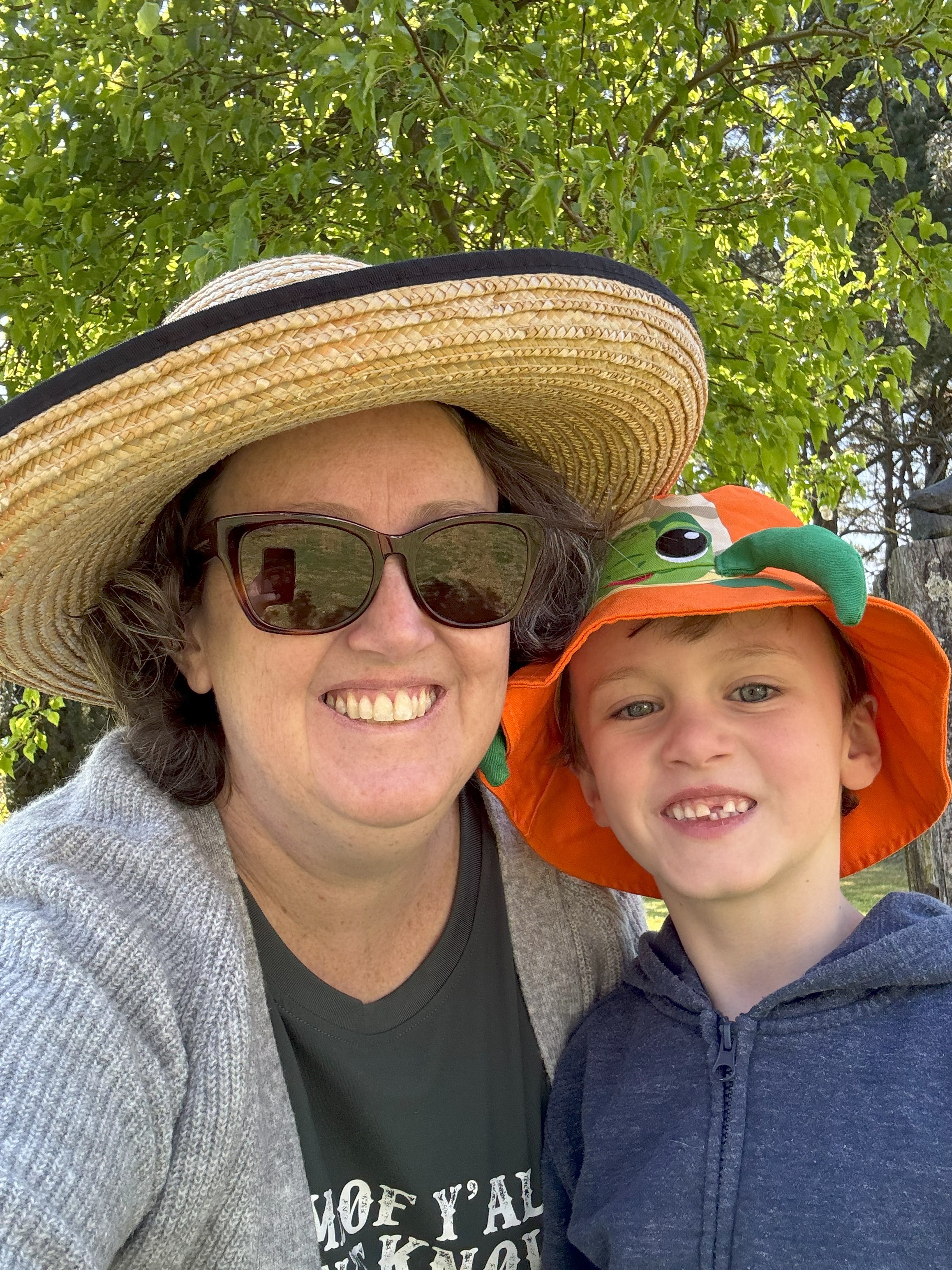 Selfie of a woman and her son looking at camera smiling