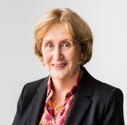 Helen McKenzie wearing a floral blouse and black blazer.