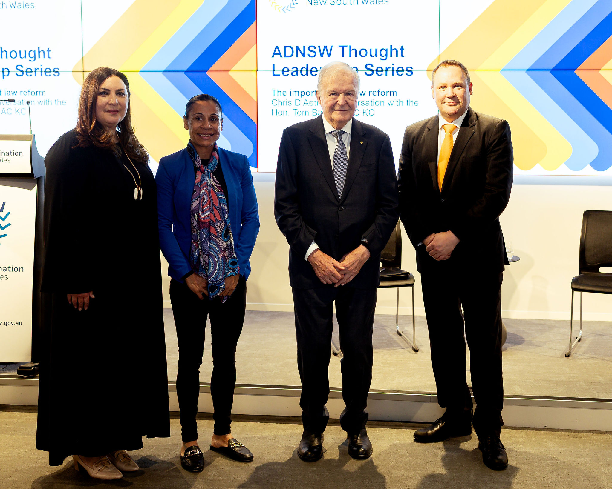 Four individuals standing in front of a backdrop featuring colorful geometric designs and the text: 'ADNSW Thought Leadership Series – The importance of law reform – Chris D'Aeth in conversation with the Hon. Tom Bathurst AC KC.' The image captures participants of the event focused on law reform.